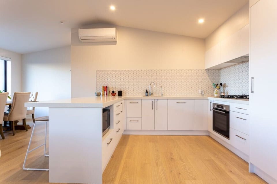 Kitchen with lots of bench space for cooking. Kitchen includes Bosch appliances (gas cooktop, oven and dishwasher), fridge/freezer, pantry, microwave, essentials provided