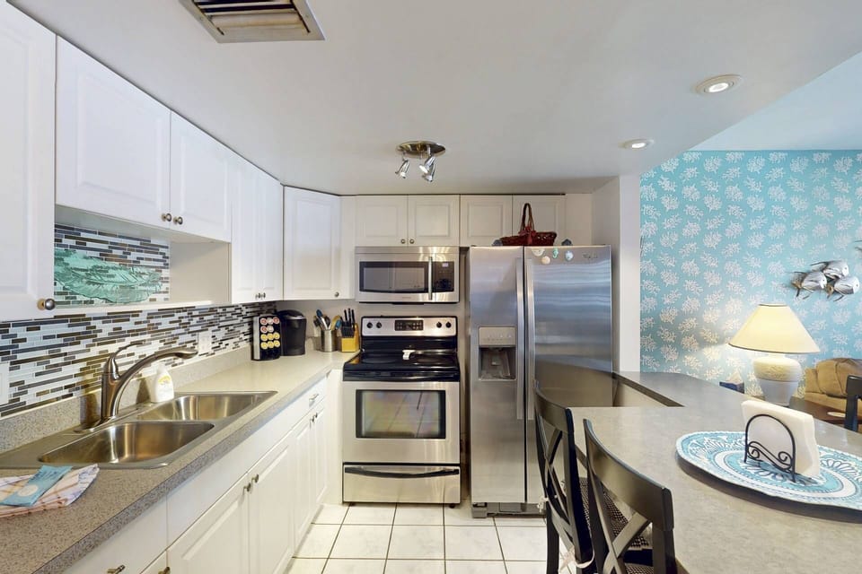 The kitchen is updated with stainless appliances and plenty of meal prep or dining space.