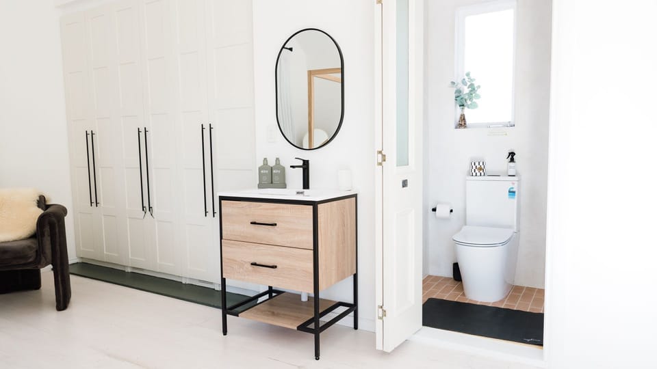 Small bathroom with shower and toilet and vanity in main room