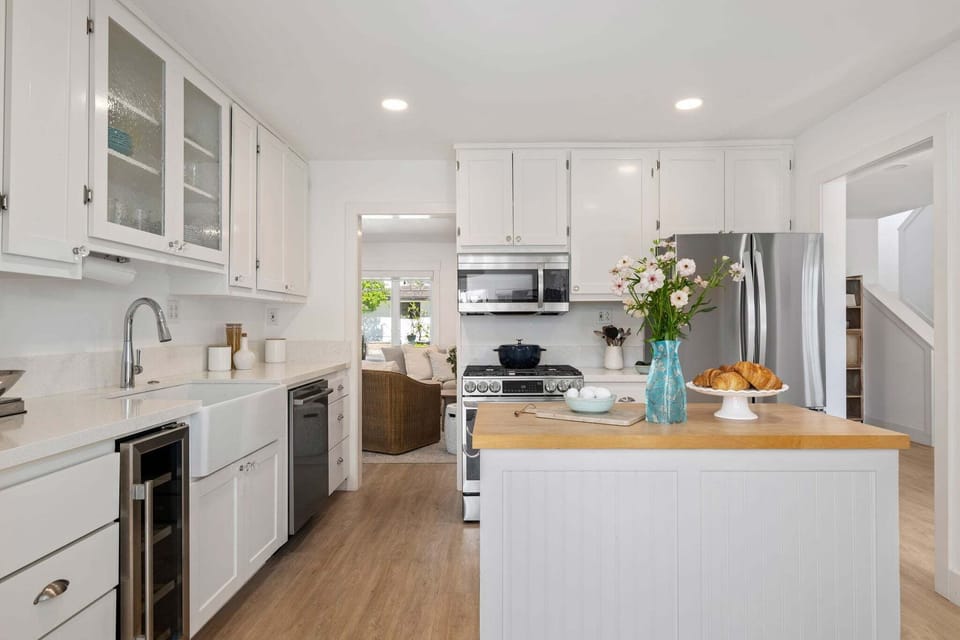 Leading into the kitchen off of the sitting room, equipped with stainless steal appliances and ample counter space!