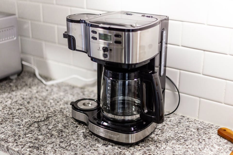 Coffee pot makes single cups or a 12-cup pot. Uses ground coffee (not pods).