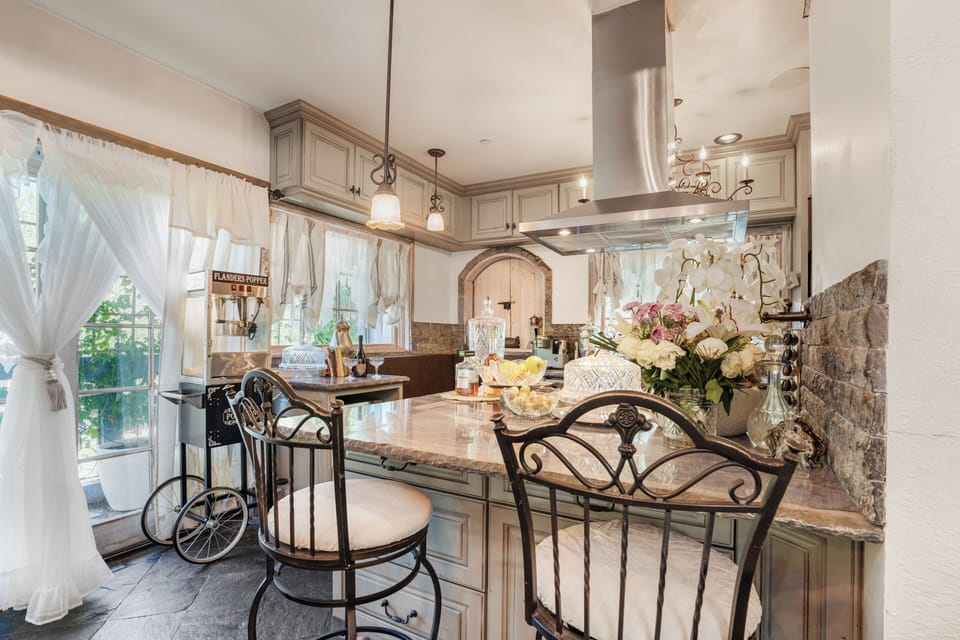 Kitchen view featuring a central island and professional hood.
