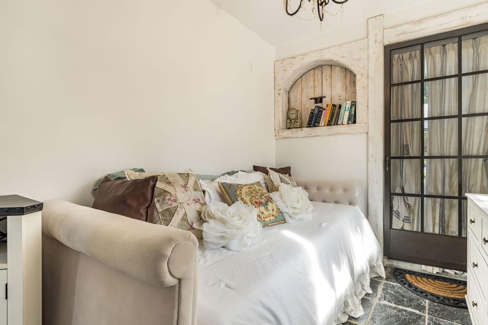 Arched stone alcove featuring a cozy twin bed.