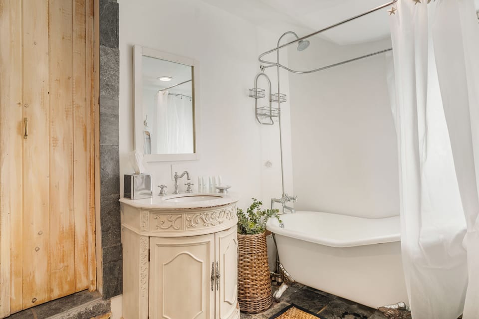 Vintage-style bathroom with a pedestal sink and clawfoot tub