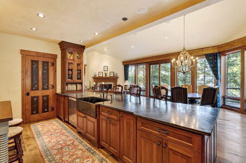 A chef’s kitchen with custom cabinetry, premium appliances, and a large island for easy gathering.