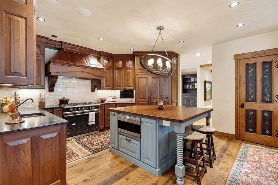 A chef’s kitchen with custom cabinetry, premium appliances, and a large island for easy gathering.