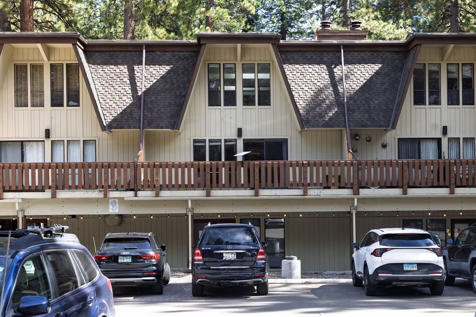 Exterior view of the A-frame townhome with balcony and garage parking