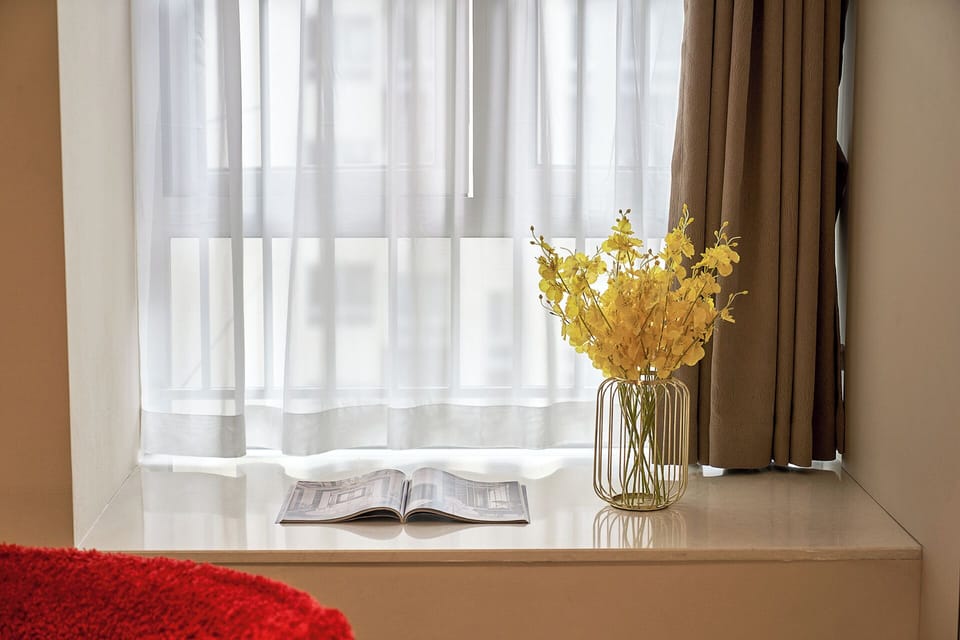 Family Suite, Balcony, City View | Living area | 65-inch TV with cable channels