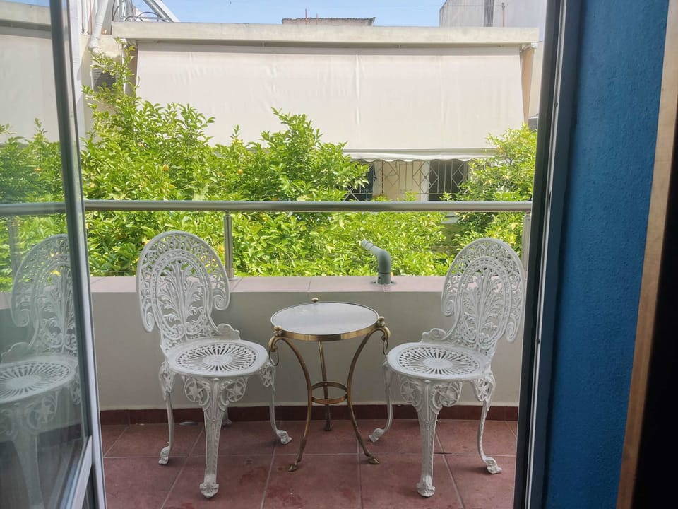 Private balcony with seating area overlooking greenery — an ideal spot for morning coffee or a peaceful break during the day.