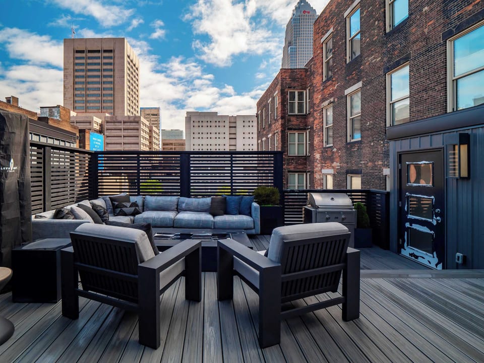 Rooftop patio w/ lounge chairs & city views, ideal for sunset hangs