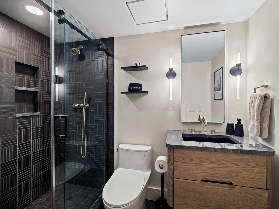 Full bathroom w/ glass shower, sleek tile & modern vanity