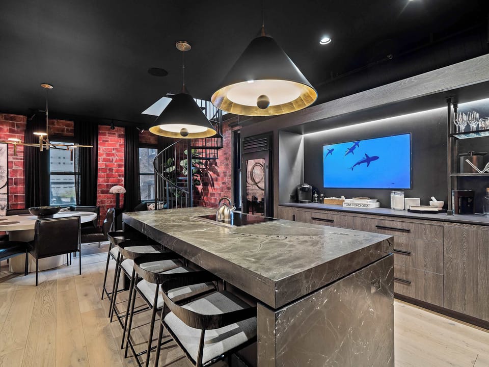 Bright kitchen w/ expansive island, modern finishes & space to gather

