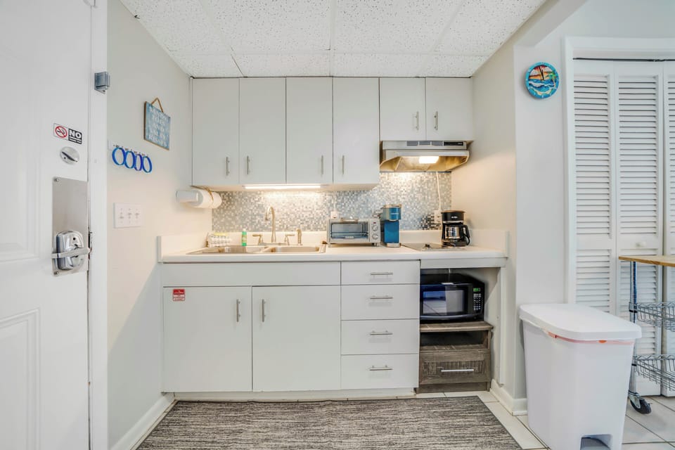 The kitchenette has a sink, microwave, toaster oven, and coffee maker.