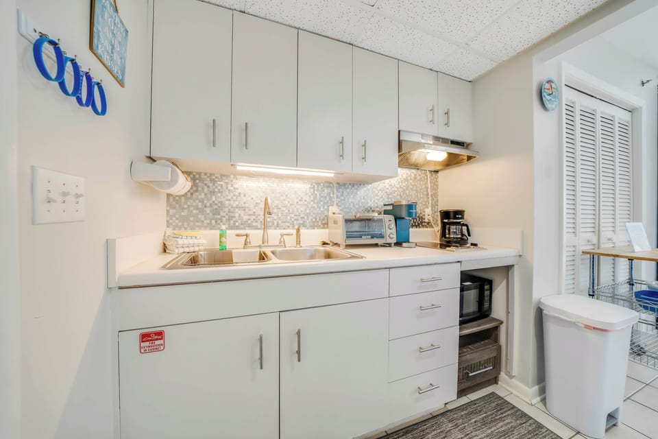 The kitchenette has a sink, microwave, toaster oven, and coffee maker.