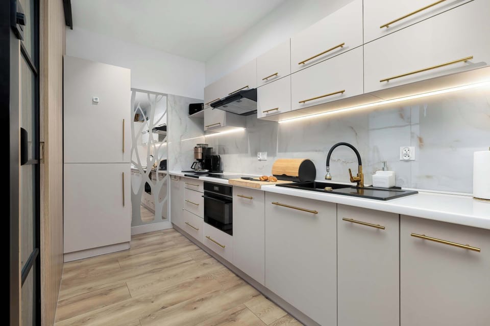 The sleek design of the kitchenette blending seamlessly with the living area.