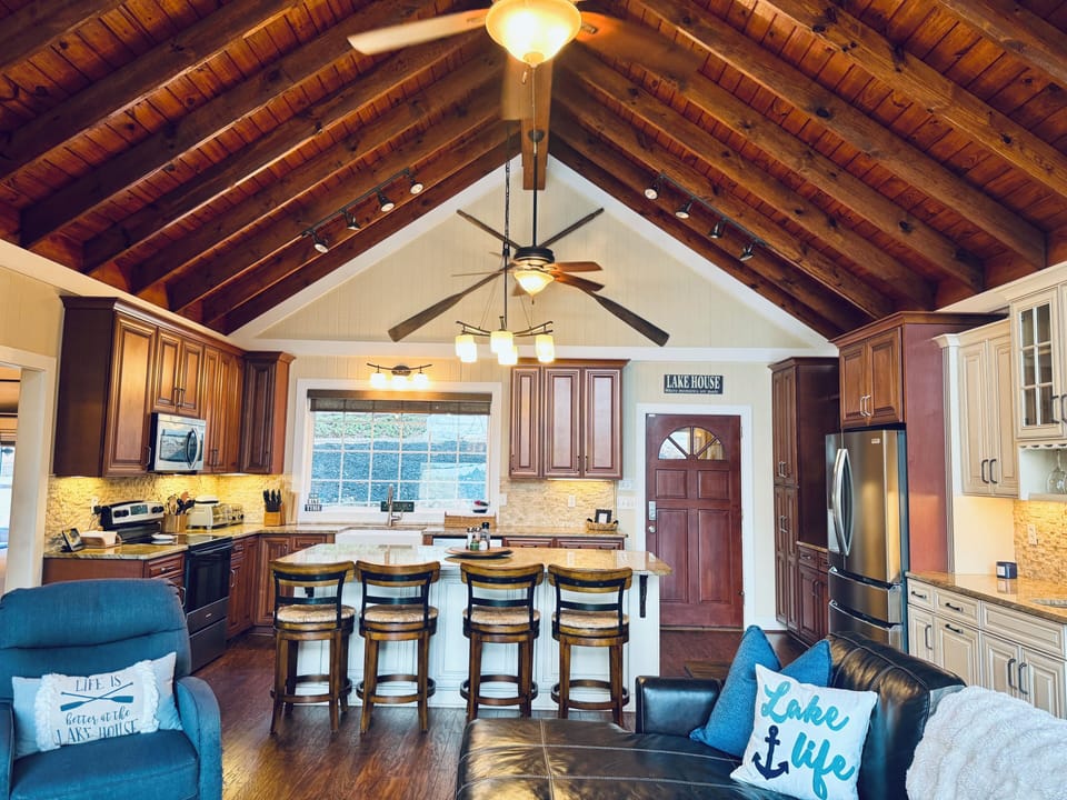 The open kitchen has big vaulted ceiling and bigger views of the lake. 