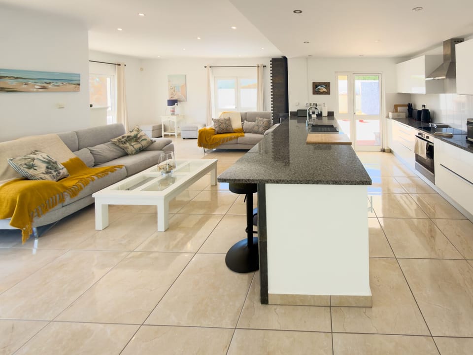 Lounge and Kitchen dining area with access to private pool