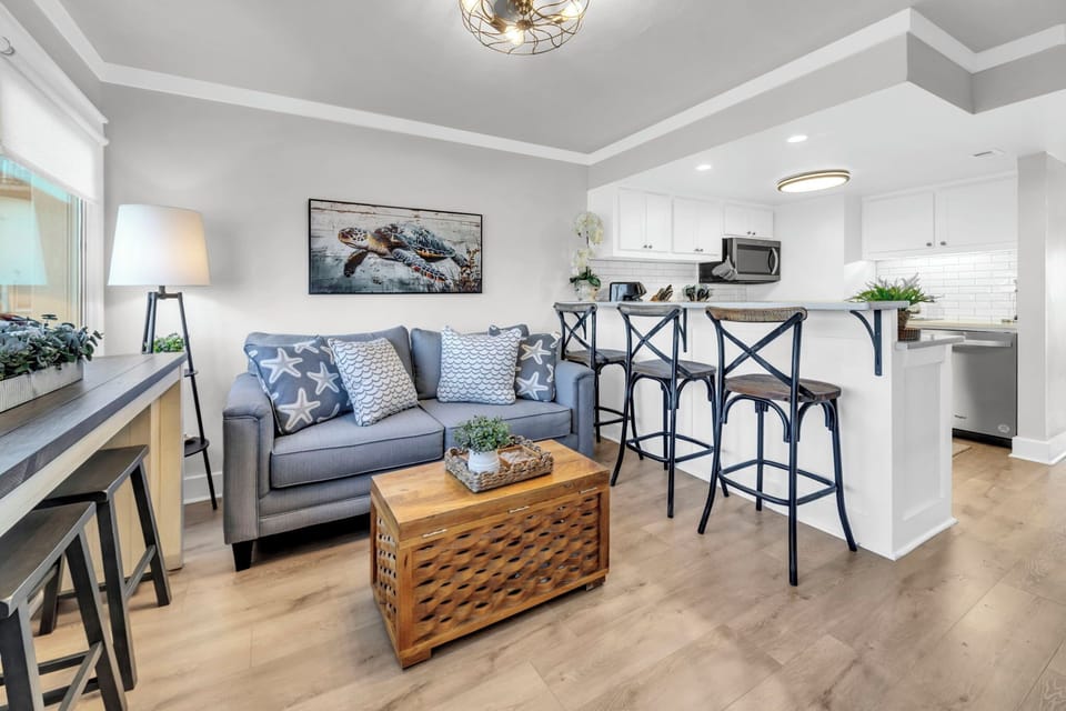 Unwind in your stylish open-concept living space, where soft gray tones and modern furnishings create the perfect atmosphere for relaxation.