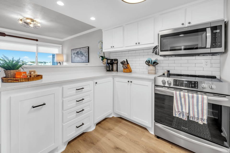 Your bright, fully-equipped kitchen makes home-cooked meals a joy with modern appliances and coastal views.