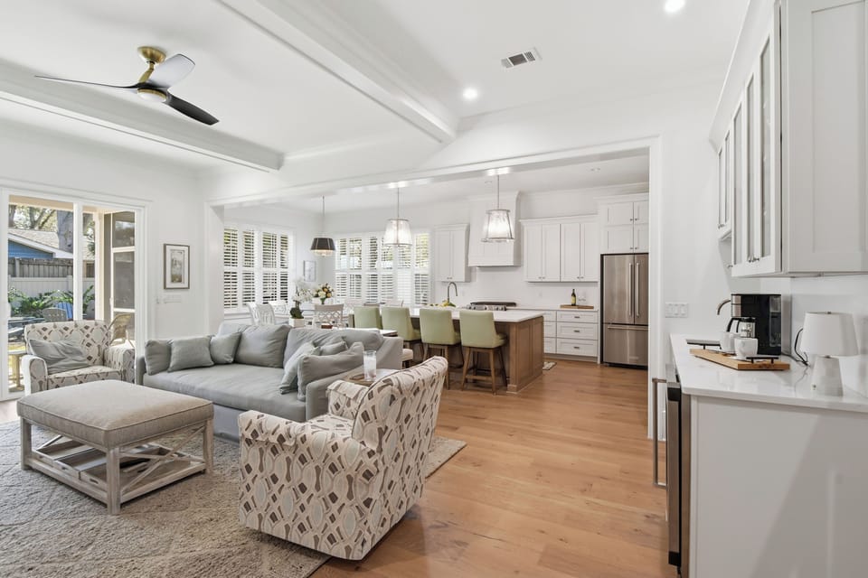 Relax in this elegant open-plan space where your modern kitchen flows into a sophisticated living area with plush seating and stylish decor.