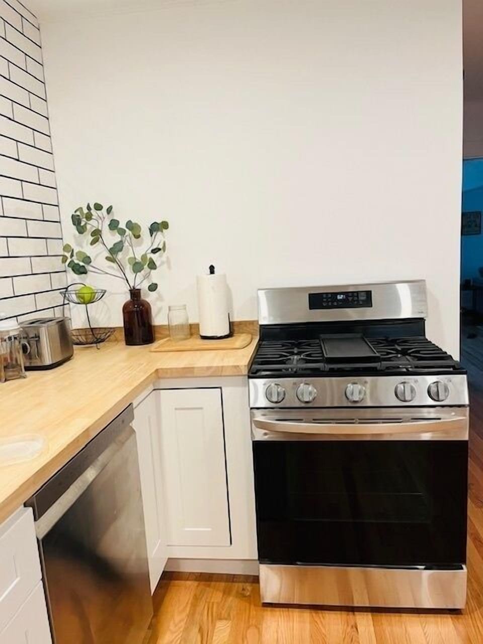 Your modern kitchen features sleek stainless steel appliances and warm wood countertops, creating the perfect space for preparing memorable meals during your stay.