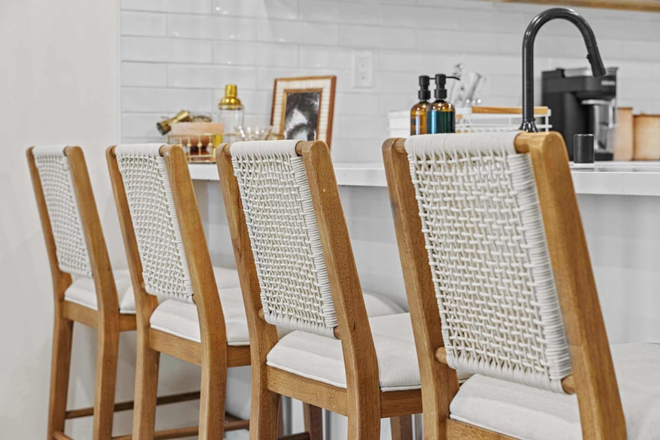 This seating area is designed to keep the conversation flowing between the kitchen and the living room, making the home feel open, and welcoming.