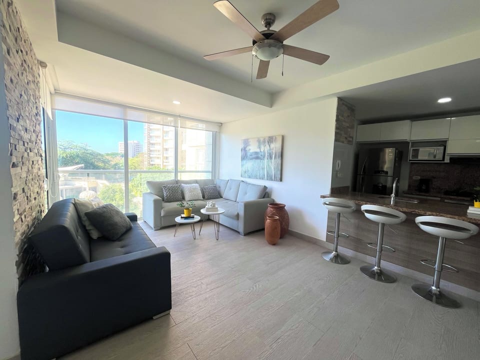 Apartment, Pool View | Living area | 50-inch flat-screen TV with digital channels