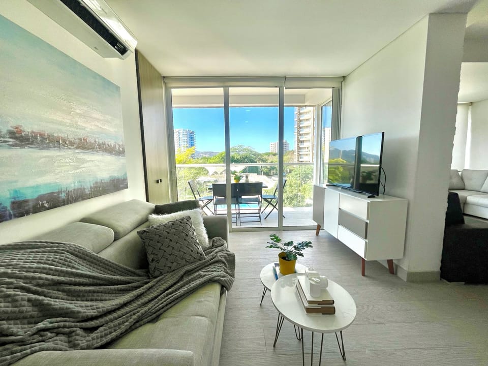 Apartment, Pool View | Living area | 50-inch flat-screen TV with digital channels