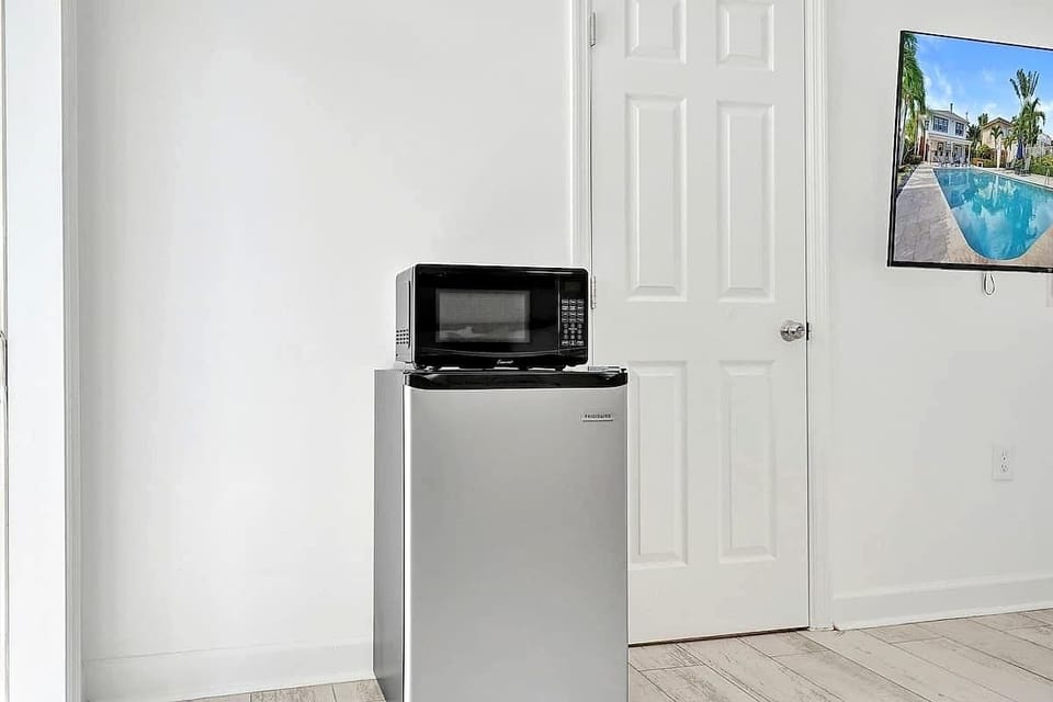 Compact mini fridge and microwave in studio