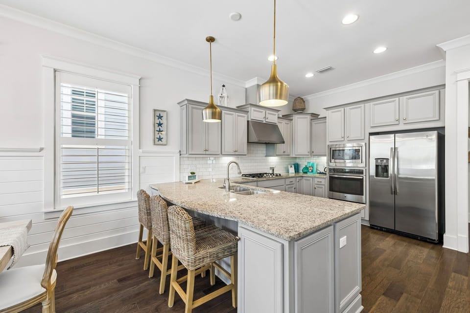 Picture yourself preparing meals in this bright, fully-equipped kitchen with granite countertops, stainless appliances, and a spacious island—perfect for gathering with loved ones.