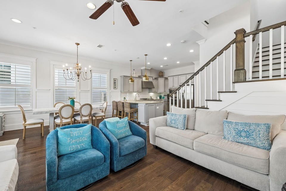 Unwind in your open-concept living space with vaulted ceilings, elegant furnishings, and a fully equipped kitchen ready for your coastal getaway.