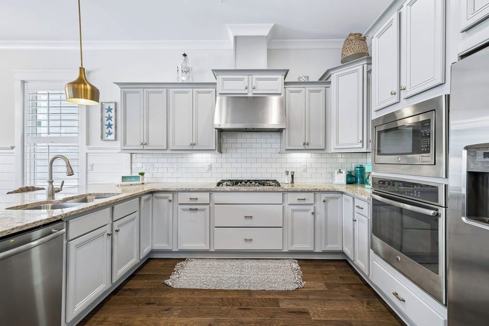 You'll love cooking in this bright, modern kitchen with sleek stainless appliances, elegant granite counters, and plenty of cabinet space for all your culinary needs.