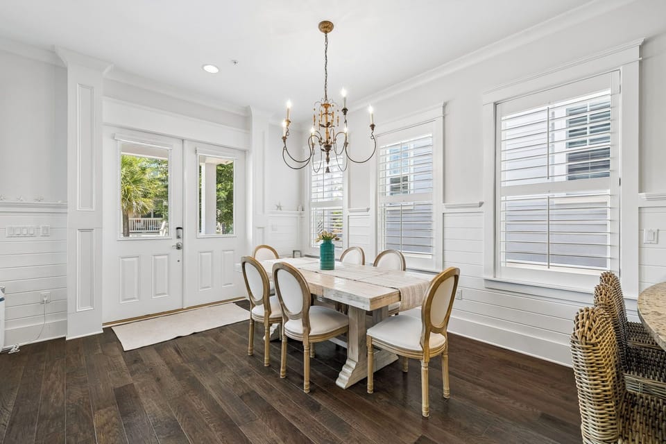 A bright and elegant dining space awaits your family meals, with a charming chandelier overhead and abundant natural light streaming through the windows to create the perfect atmosphere for memorable gatherings.