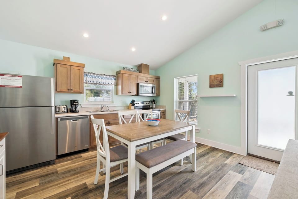 Gather around your spacious kitchen table for morning coffee and home-cooked meals in this bright, fully-equipped space with modern appliances.