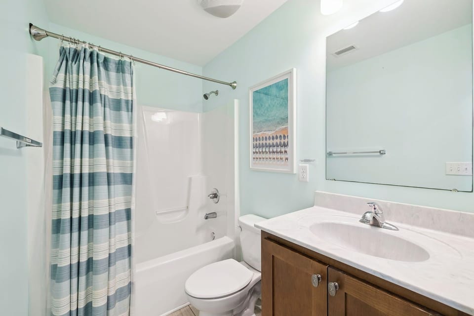 Your private bathroom features a soothing palette with a full tub-shower combo, perfect for unwinding after your adventures.