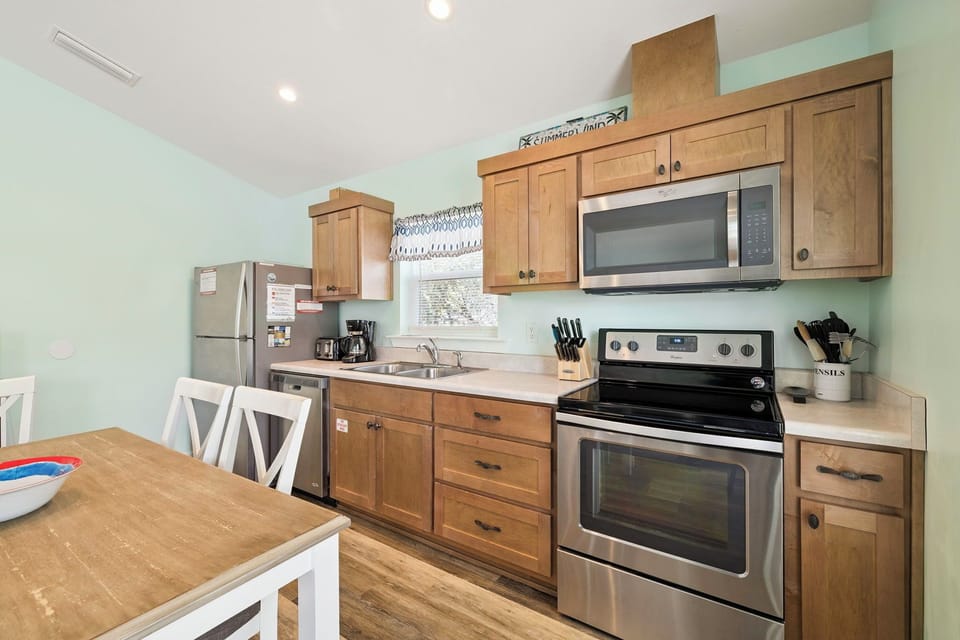Your fully equipped kitchen features warm wood cabinets, stainless appliances, and everything you need to prepare delicious meals during your stay.