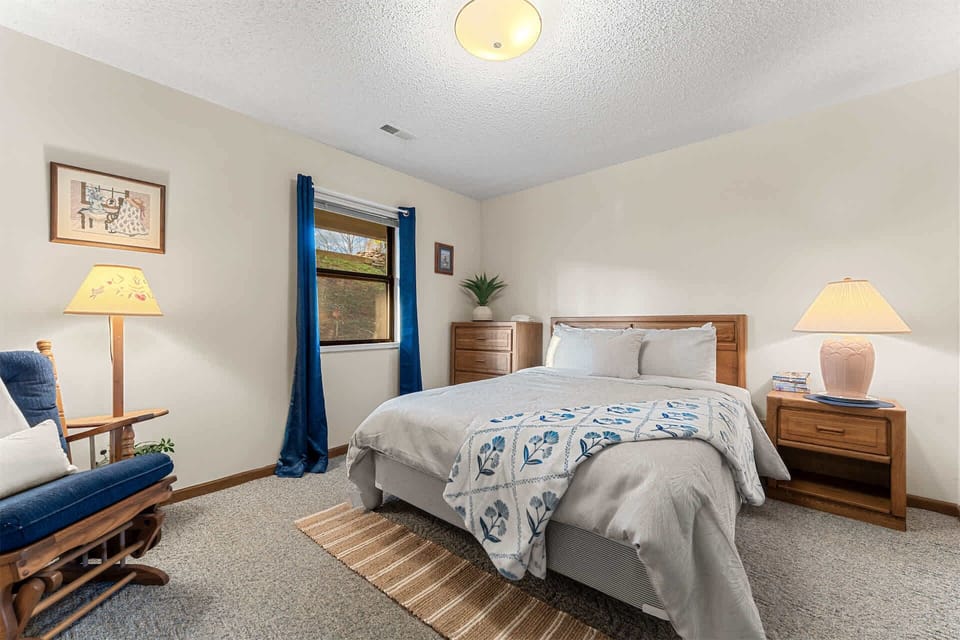 The bedroom retreat includes a plush queen-sized bed & smart TV​