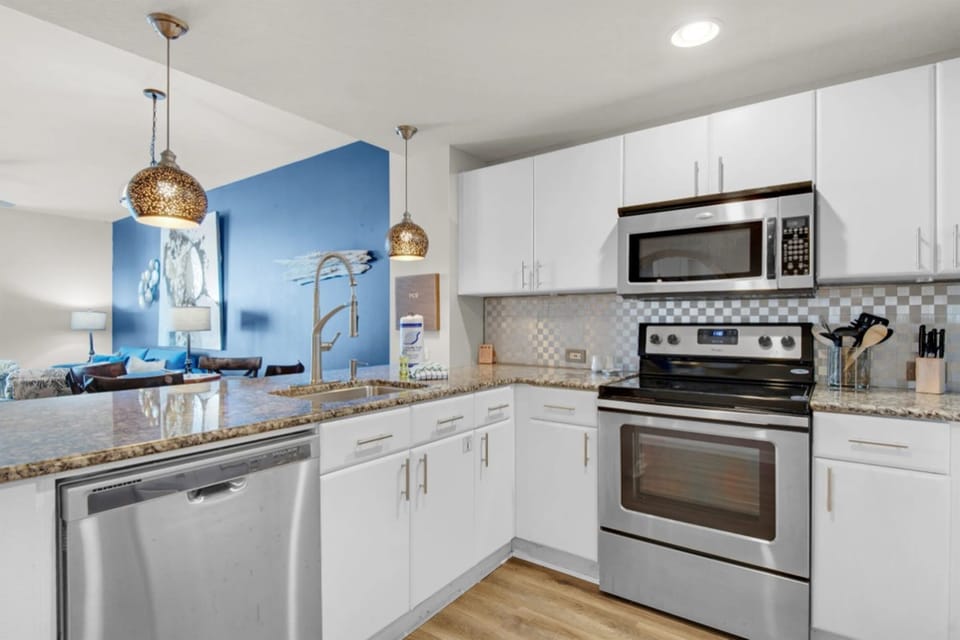 Your fully equipped kitchen features granite counters, stainless appliances, and an open layout perfect for preparing meals during your stay.