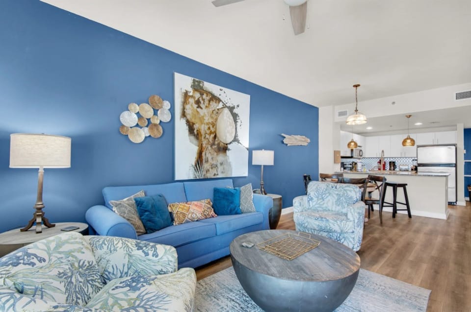 Sink into coastal-inspired comfort in your open-concept living space, where ocean blues and nautical touches create your perfect seaside retreat.