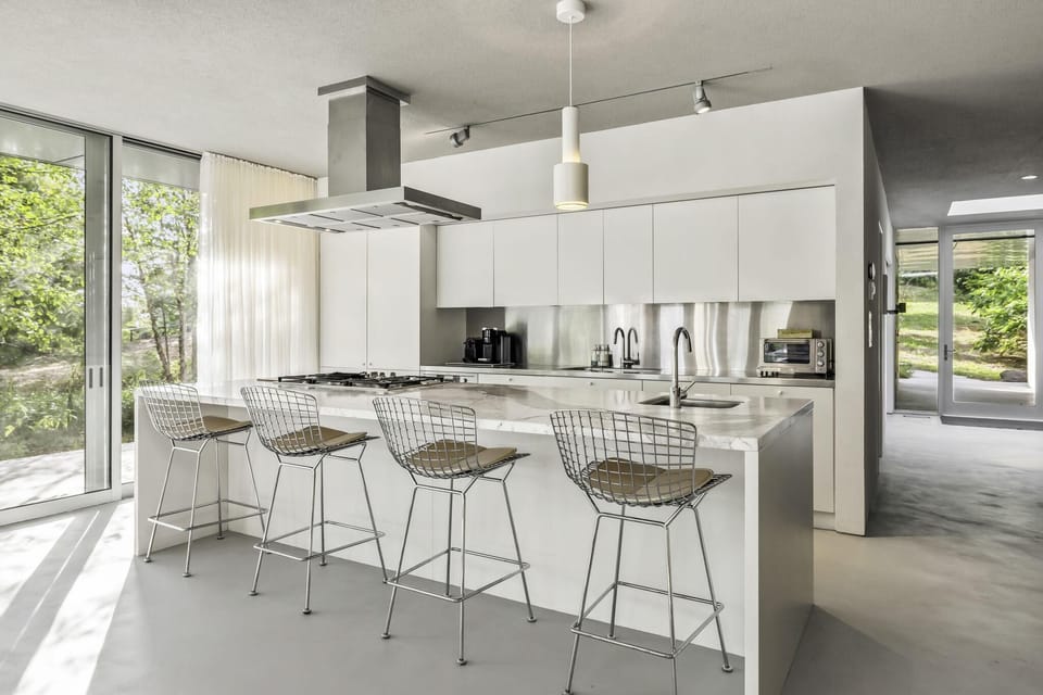 Sunlit kitchen with island seating and sliding glass doors