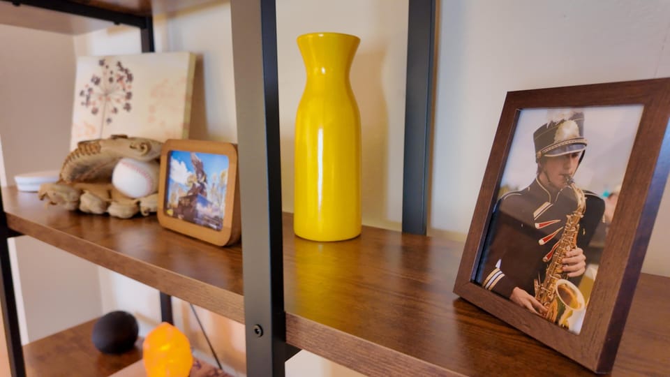 Cozy living room shelf with personal touches and warm decor