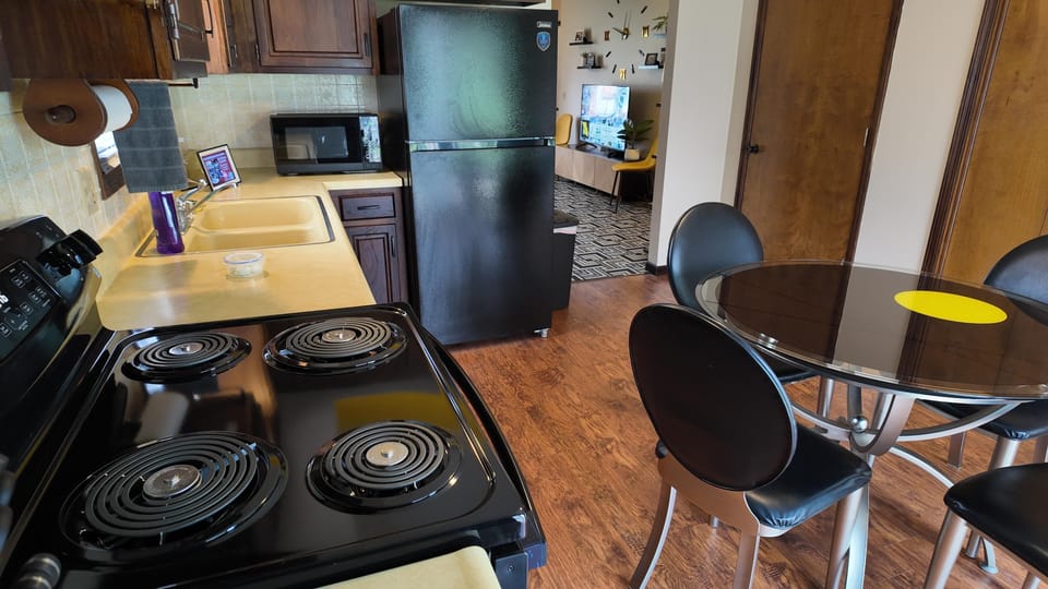 Cozy kitchen and dining area with modern appliances and warm wood accents