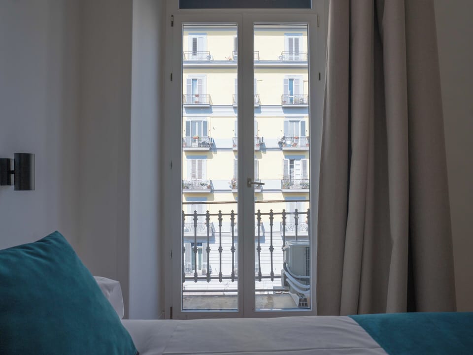 Family Quadruple Room, City View | In-room safe, desk, laptop workspace, blackout drapes