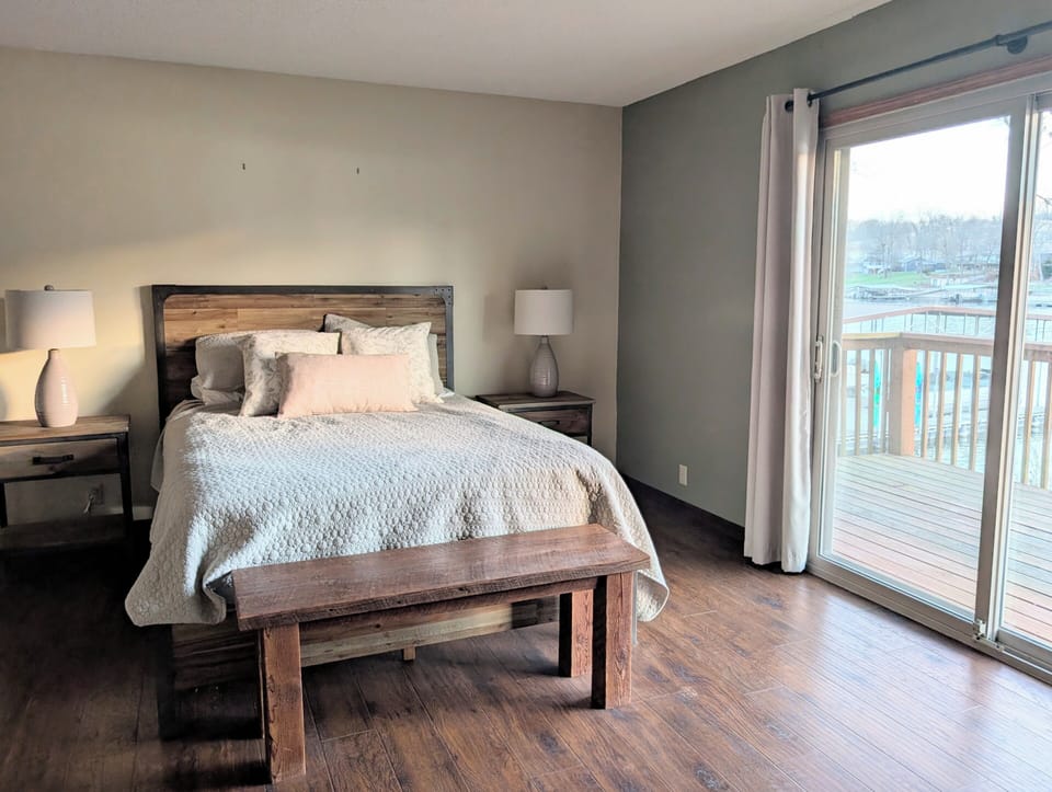 Bedroom 1• Attached Bathroom • Bed linens• Dresser • TV • Deck access