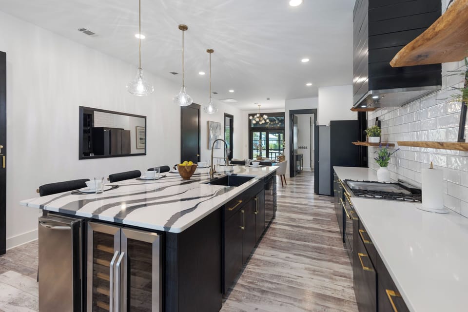 Your gourmet kitchen awaits with marble countertops, premium appliances, and a spacious island perfect for cooking memorable meals together.