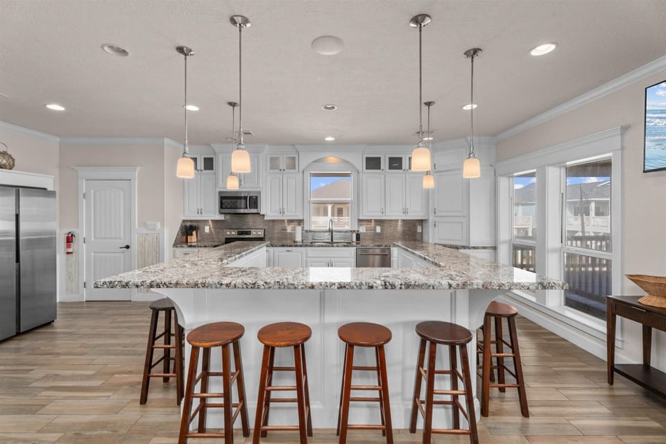 Large kitchen island with bar seating and pendant lighting