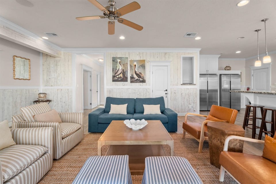 Bright open living room with modern seating and coastal decor