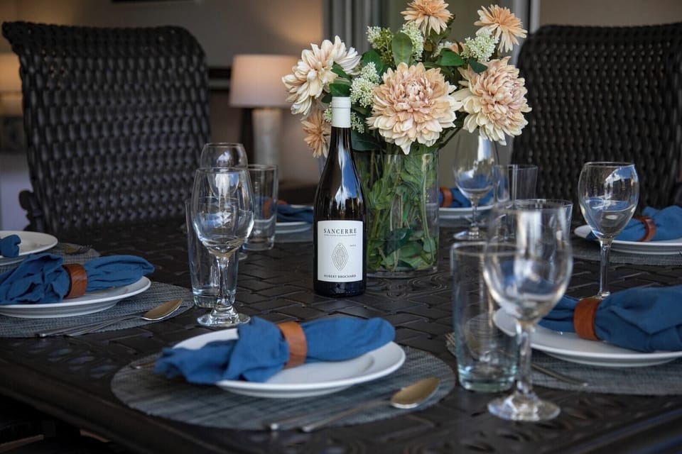 Elegant table setting with wine, florals, and coastal dinner ambiance HKH-236