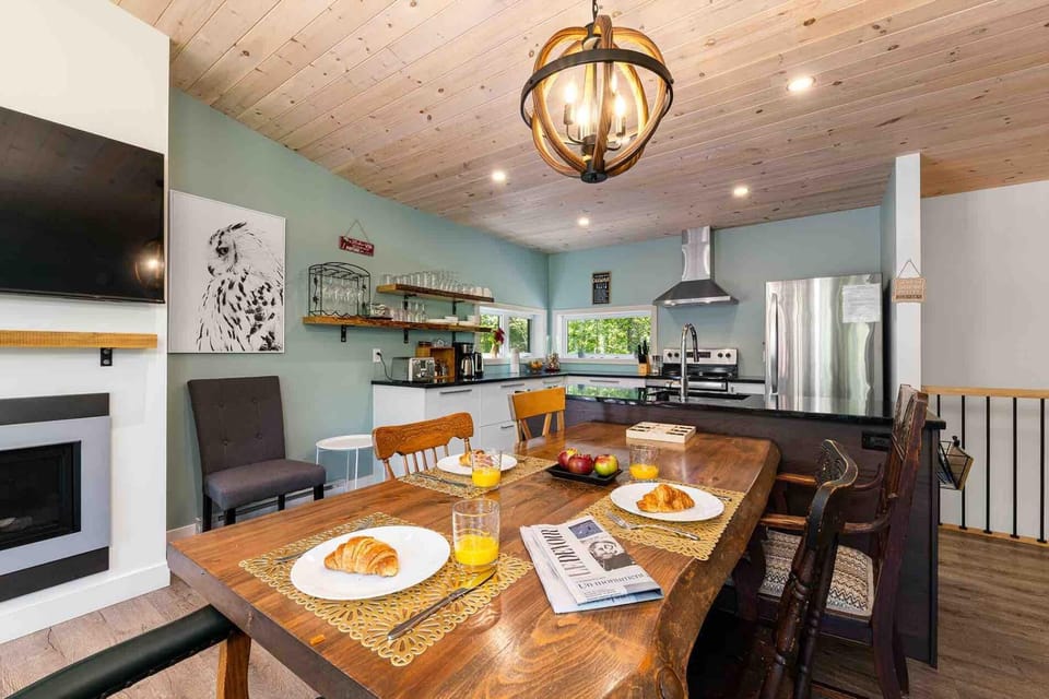 Gather for meals at the spacious dining table beside the open kitchen.