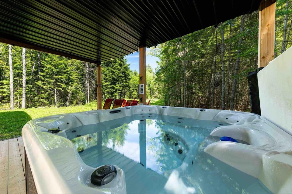 Soak in the private hot tub beneath the covered outdoor patio.